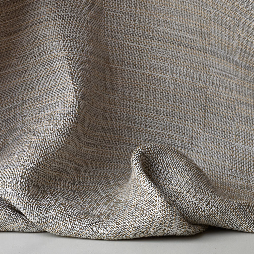 Muted greige-gold sheer fabric with fine herringbone weave in soft draped folds