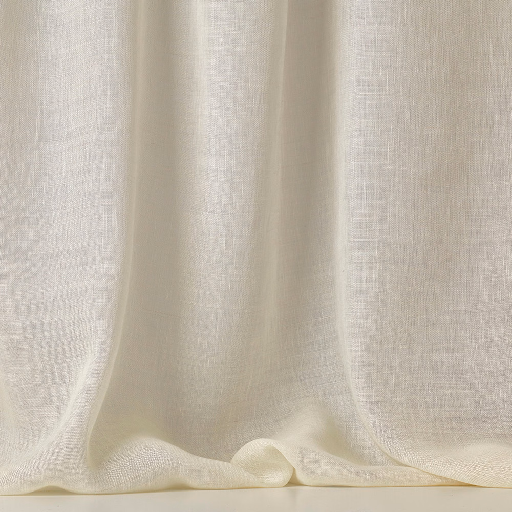 Warm ivory sheer fabric with fine open weave gathered into soft flowing folds