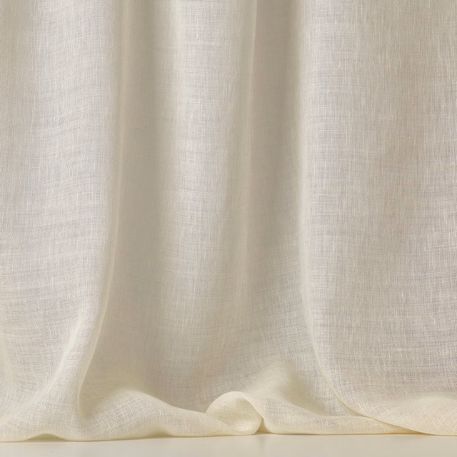 Warm ivory sheer fabric with fine open weave gathered into soft flowing folds