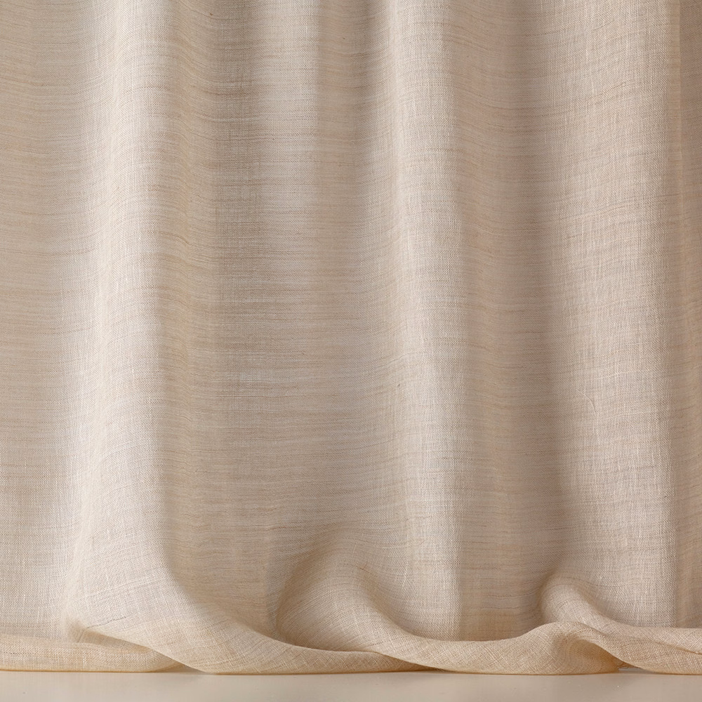 Warm sand-beige sheer weave falling in soft vertical folds with translucent light