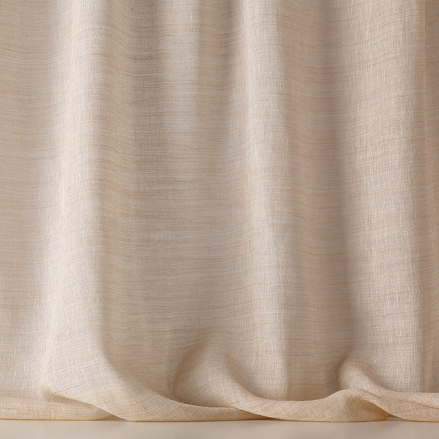 Warm sand-beige sheer weave falling in soft vertical folds with translucent light