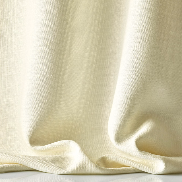 Warm ivory sheer linen with a fine weave falling into softly pooled folds
