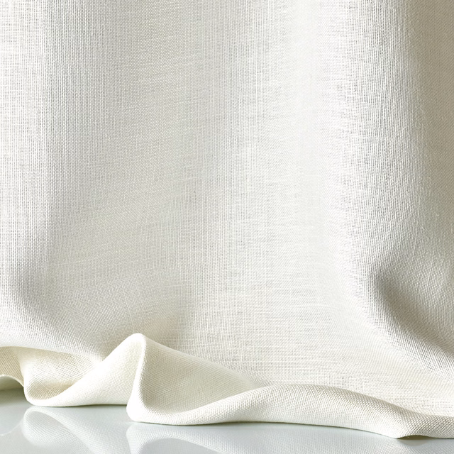Warm ivory sheer fabric with fine crosshatch weave and soft draped folds