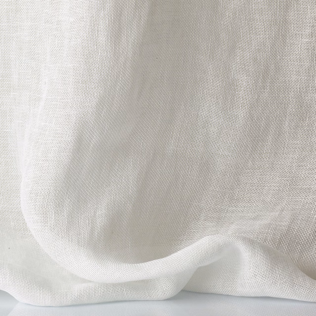 Soft white sheer open-weave fabric gathered into a translucent curved fold