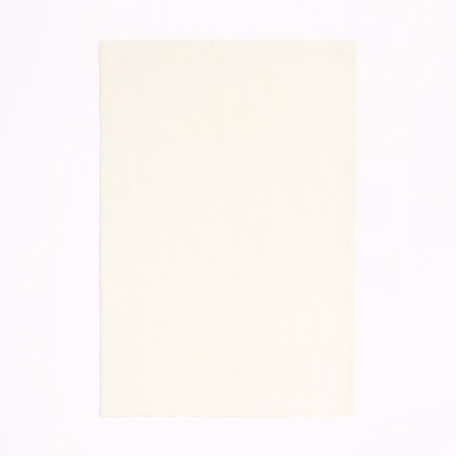 Pale warm ivory sheer fabric with an almost invisible fine plain weave