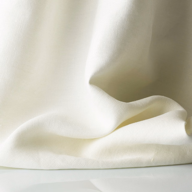 Warm ivory sheer weave gathered into soft, translucent folds