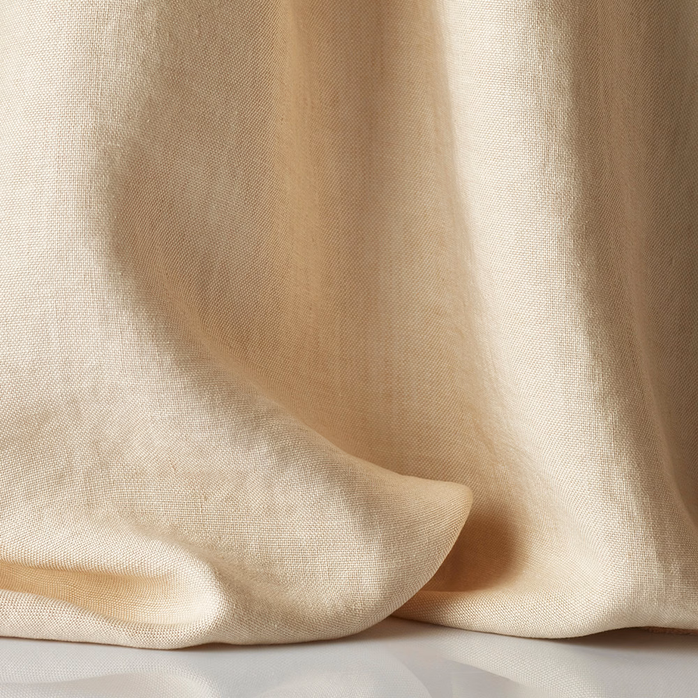 Sheer blush-beige textile pooling in soft folds, with a fine linen-like weave