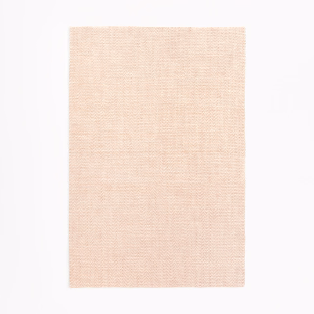 Pale blush-pink sheer fabric swatch with a fine, softly crosshatched weave