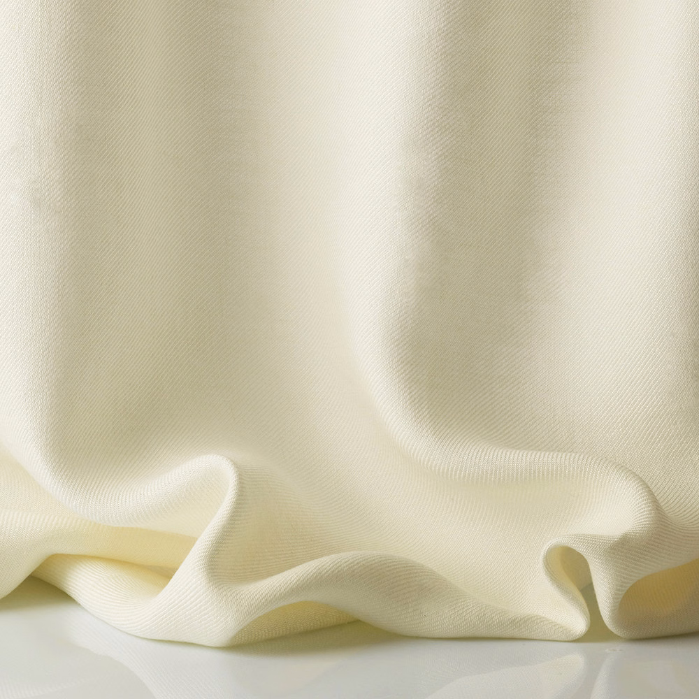 Warm ivory sheer fabric with fine woven texture gathered into soft flowing folds