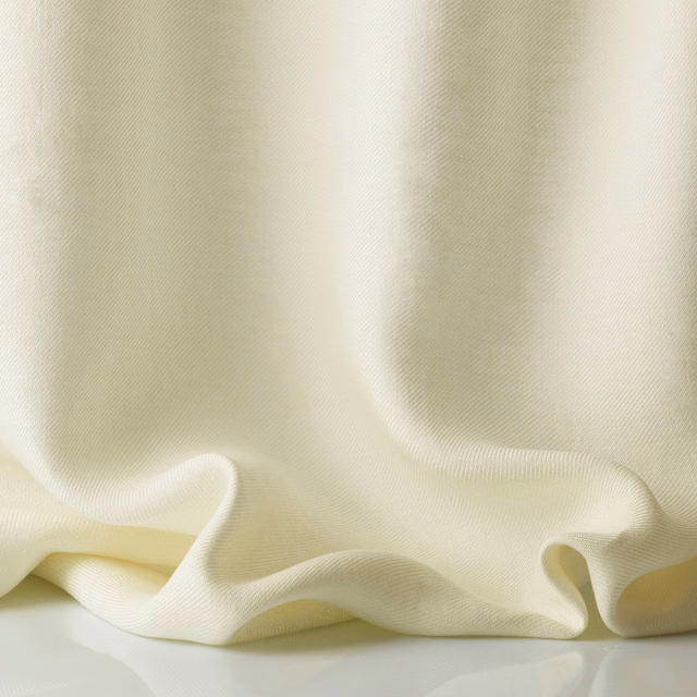 Warm ivory sheer fabric with fine woven texture gathered into soft flowing folds