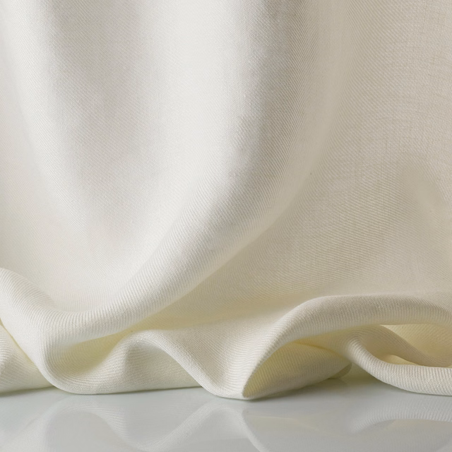 Warm ivory sheer textile with fine ribbed weave gathered into soft folds