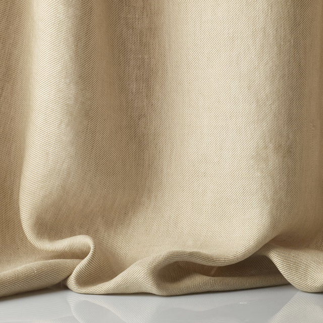 Warm sable sheer with fine ribbed weave gathered into fluid curtain folds