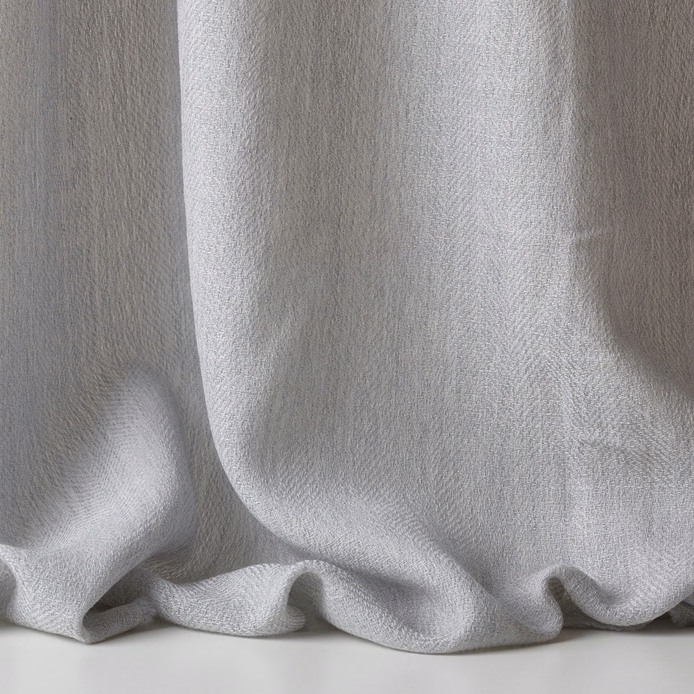 Pale silvery-grey sheer weave falling in soft, rounded curtain folds