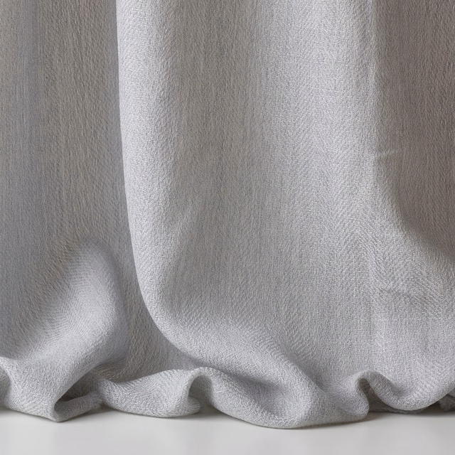 Pale silvery-grey sheer weave falling in soft, rounded curtain folds