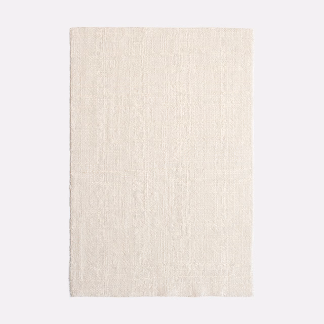 Pale ivory sheer fabric with fine vertical slub texture in close-up