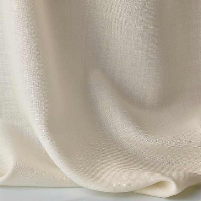 Warm ivory sheer fabric with fine weave draped in softly rounded folds