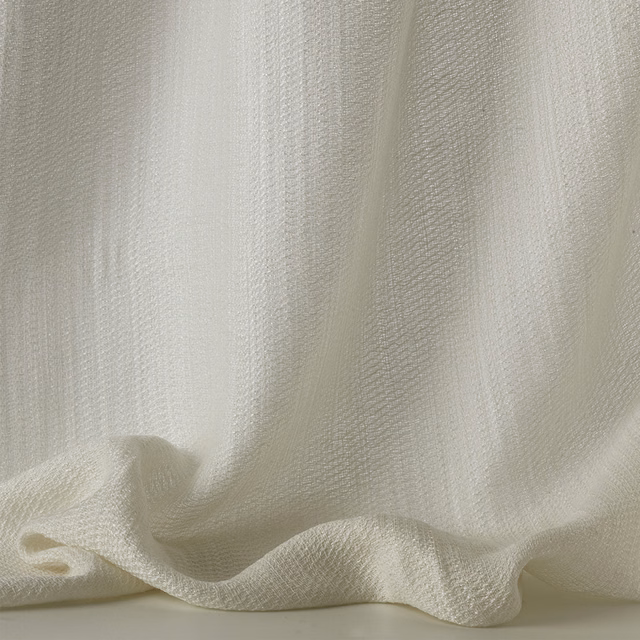 Ivory sheer textile with a fine rippled weave falling into soft folds