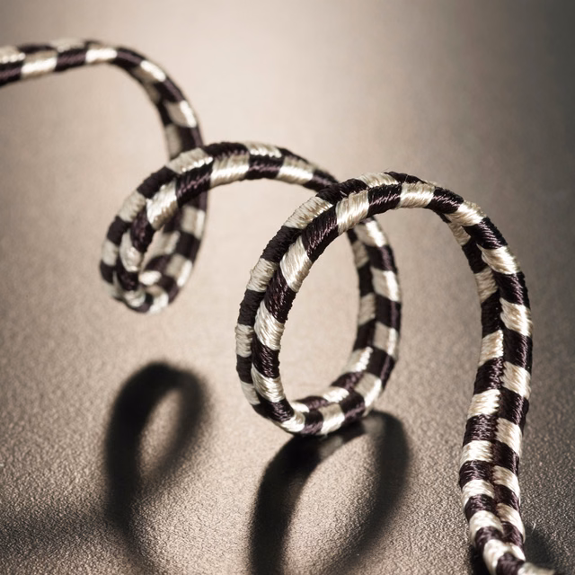 Ivory and near-black striped soutache cord looping with raised ribbed texture and shadows