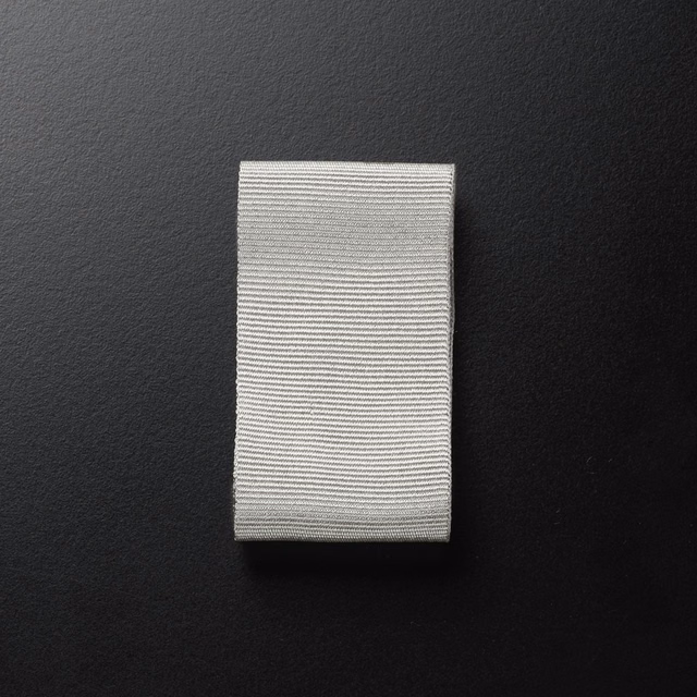 Silvery-grey fabric swatch with fine horizontal ribbed lines and subtle texture