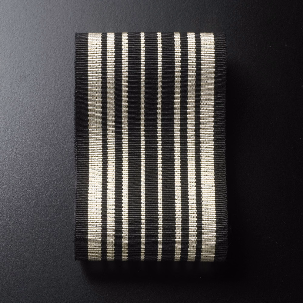 Black and warm ivory vertical stripes with a fine ribbed woven surface