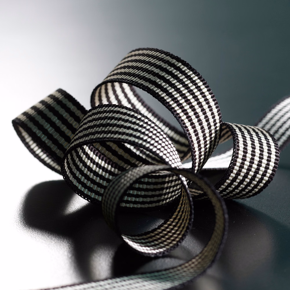 Black-and-ivory striped braid curled into loops with raised woven ribs