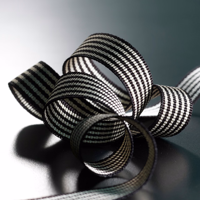 Black-and-ivory striped braid curled into loops with raised woven ribs