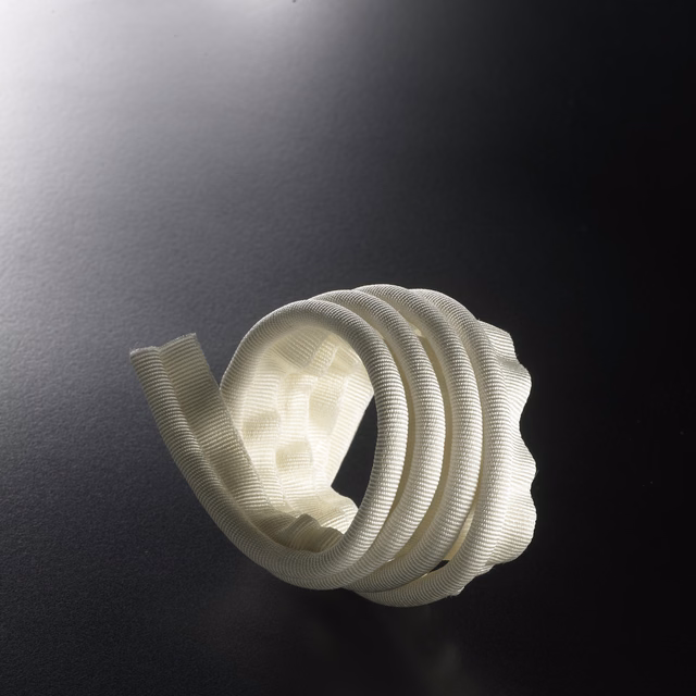 Pale ivory ribbed lipcord trim coiled into layered sculptural loops