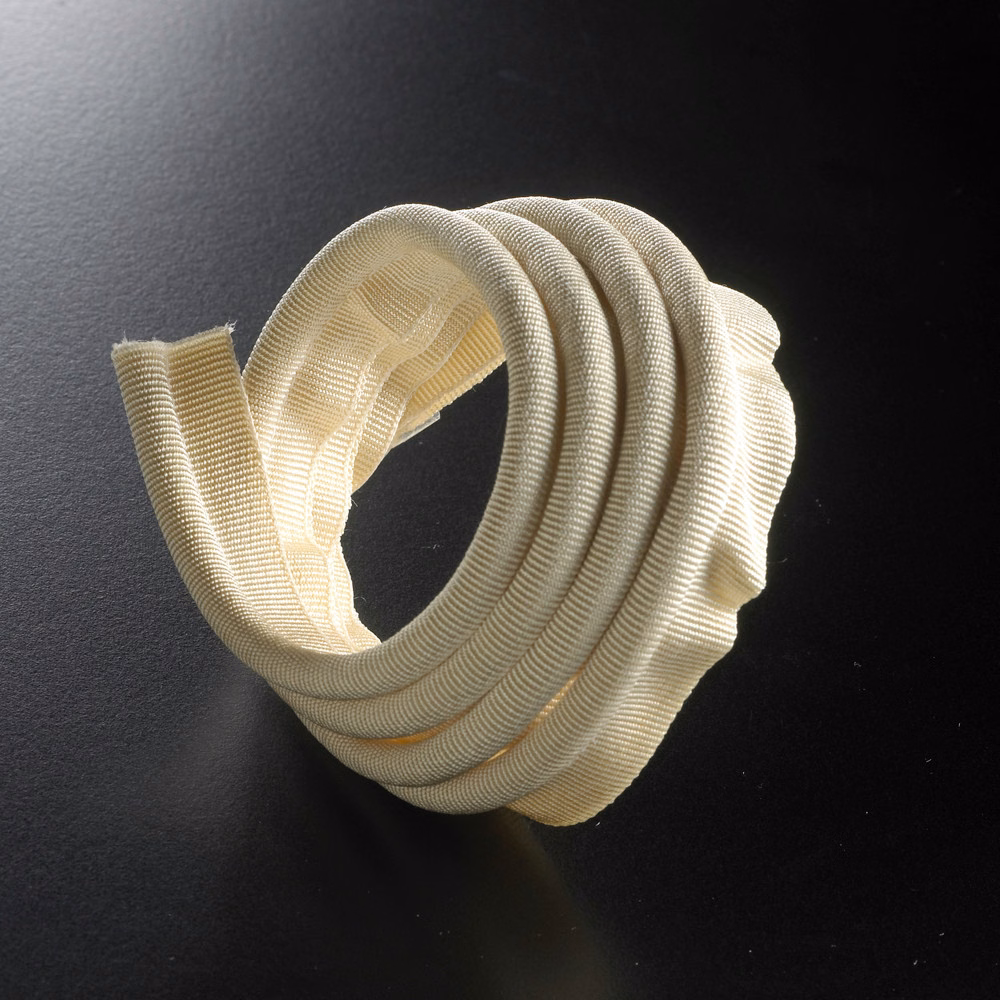 Warm ivory ribbed lipcord trim looped into a sculptural coil
