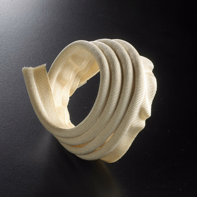 Warm ivory ribbed lipcord trim looped into a sculptural coil