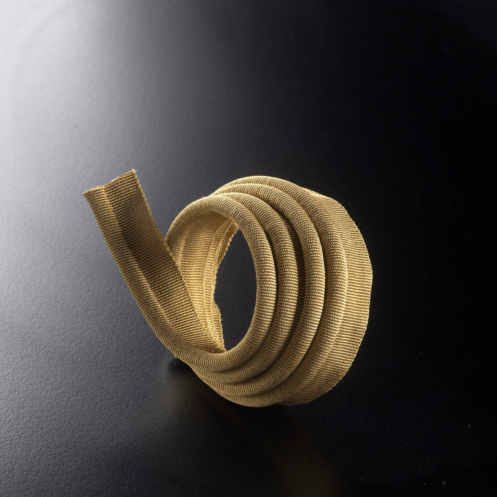 Golden-beige ribbed lipcord coiled to show its rounded, light-catching texture