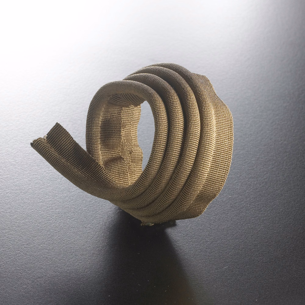 Warm mushroom-taupe ribbed cord coiled to show its rounded textured profile