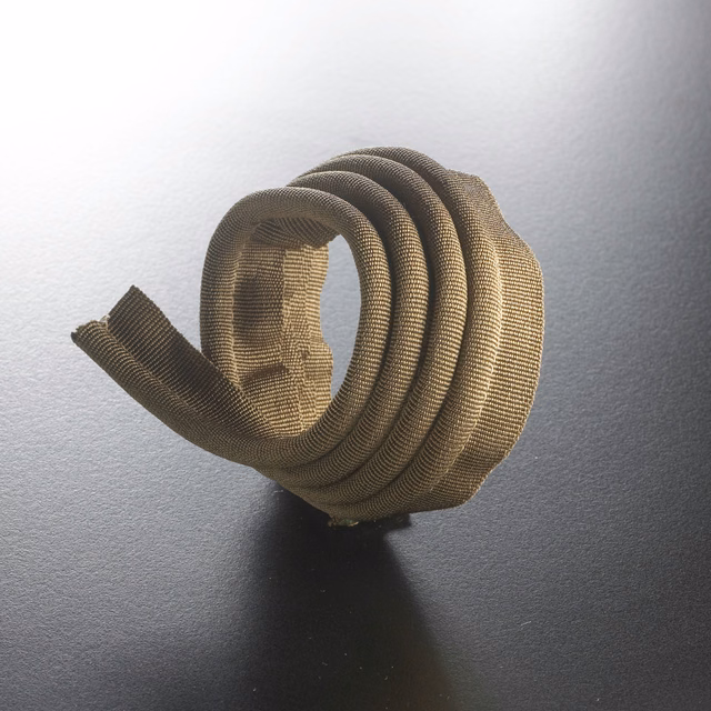 Warm mushroom-taupe ribbed cord coiled to show its rounded textured profile