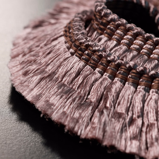 Muted mauve-pink fringe with dark brown braided header in close-up