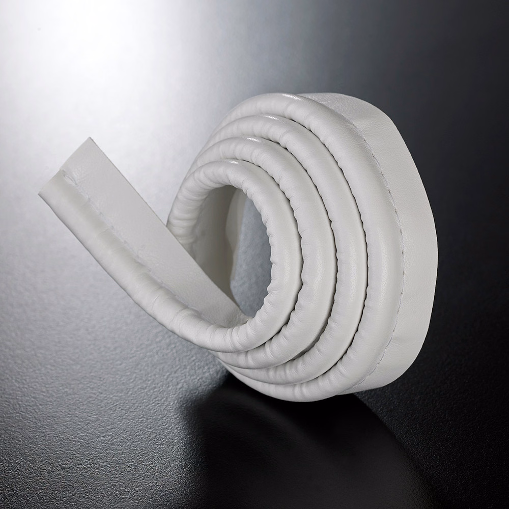 Rolled white padded lipcord showing rounded ridges and a smooth flat edge