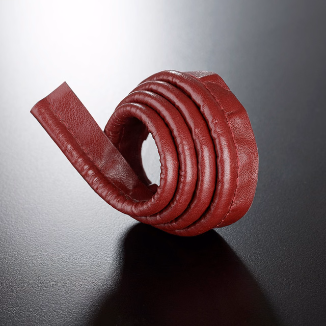 Deep Bordeaux-red pebbled lipcord coiled into a rounded spiral