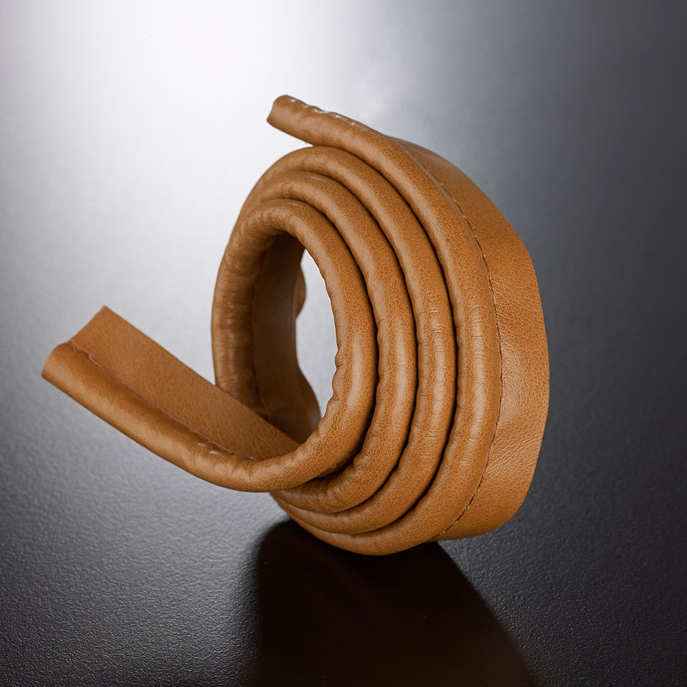 Warm caramel-brown rounded lipcord with ridged coils and a subtly pebbled surface