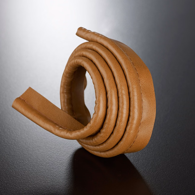 Warm caramel-brown rounded lipcord with ridged coils and a subtly pebbled surface
