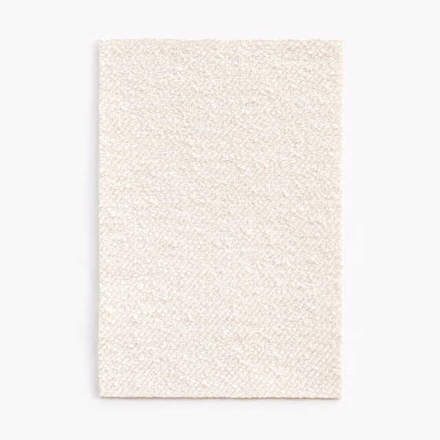 Warm white finely woven upholstery swatch with a softly pebbled surface