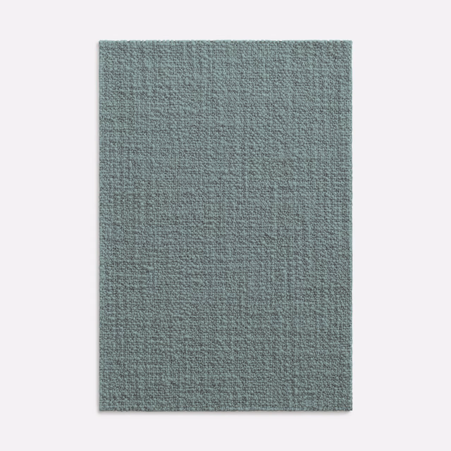 Cool grey-green celadon upholstery swatch showing a close, softly nubby woven texture