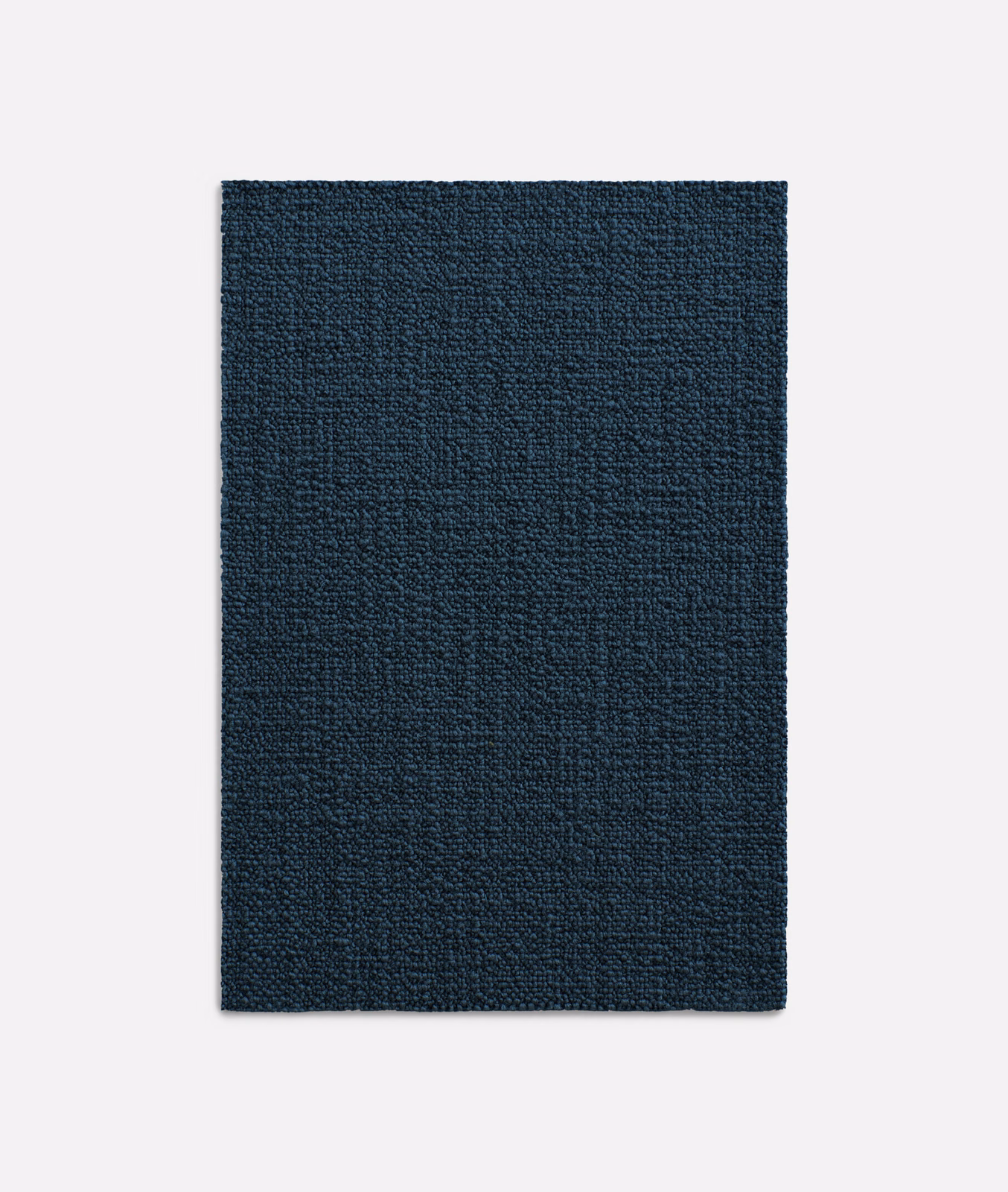 Close-up of dark indigo woven fabric with subtle tonal texture and low sheen