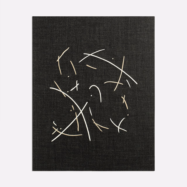 Charcoal woven fabric with scattered ivory abstract lines and fine textured ground