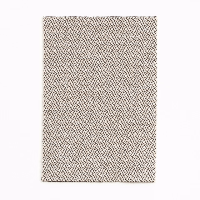 Warm coconut cream textile with a fine, dark herringbone weave