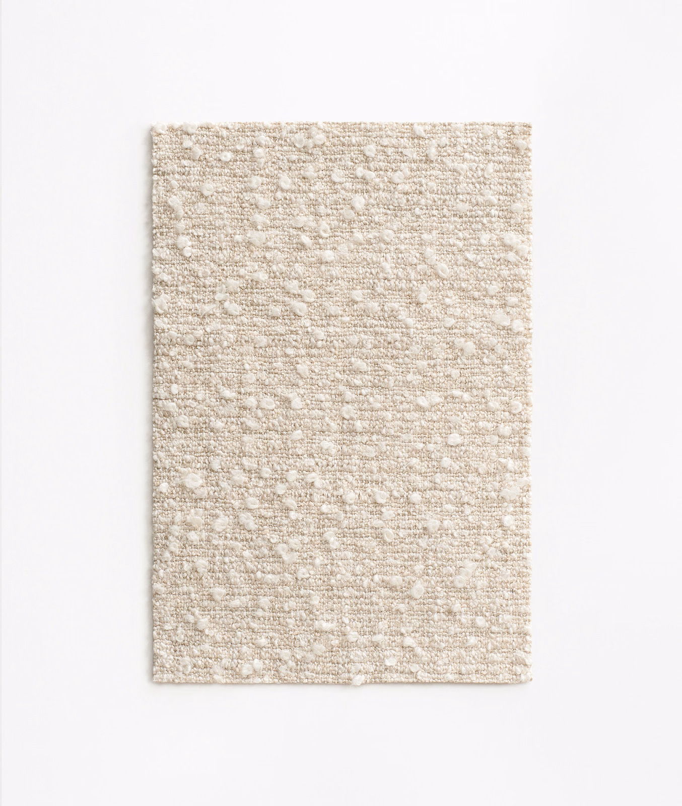 Warm ivory-beige upholstery weave with horizontal slubs and scattered raised flecks