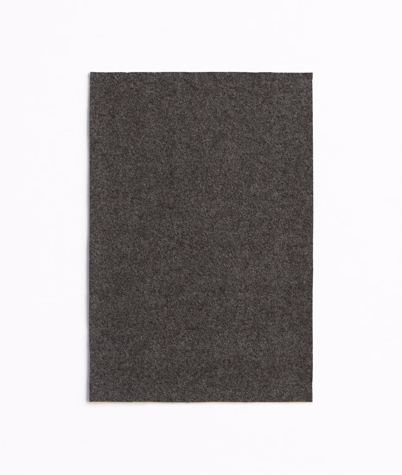 Deep charcoal grey textile swatch with a finely mottled, near-black surface
