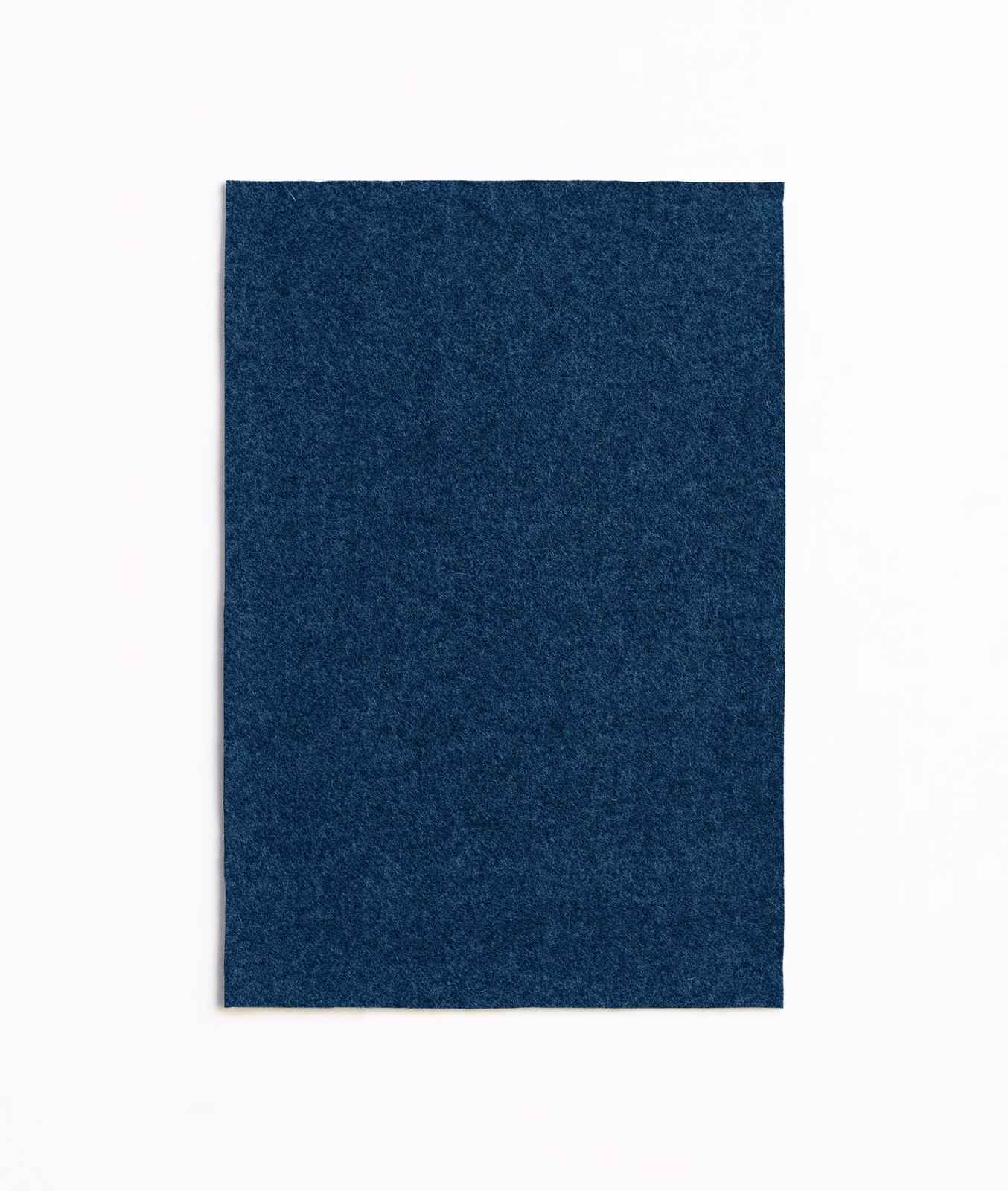 Deep indigo upholstery swatch with a subtly mottled, softly textured surface