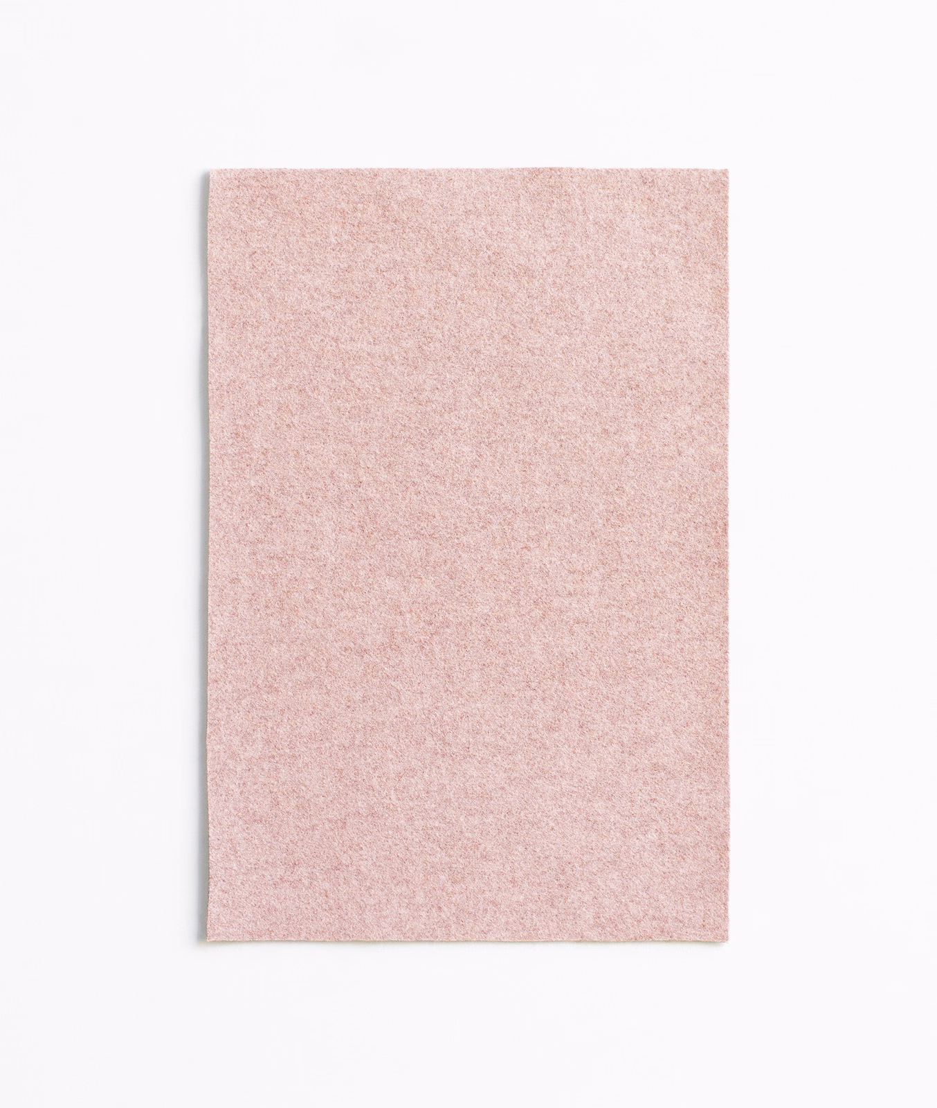 Pale dusty rose upholstery fabric with a fine, softly mottled surface