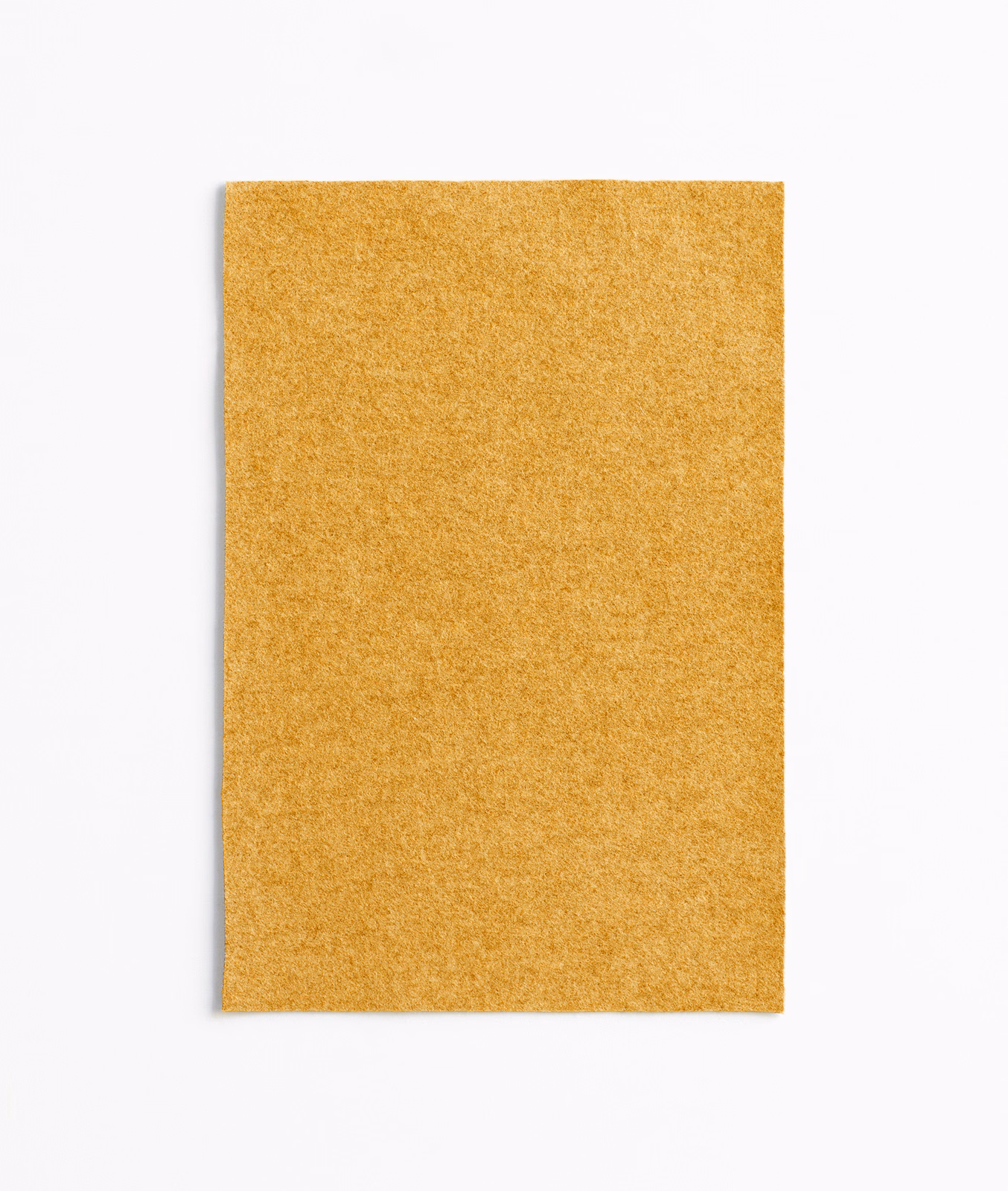 Dense mottled mustard-yellow upholstery fabric with a softly textured plain surface