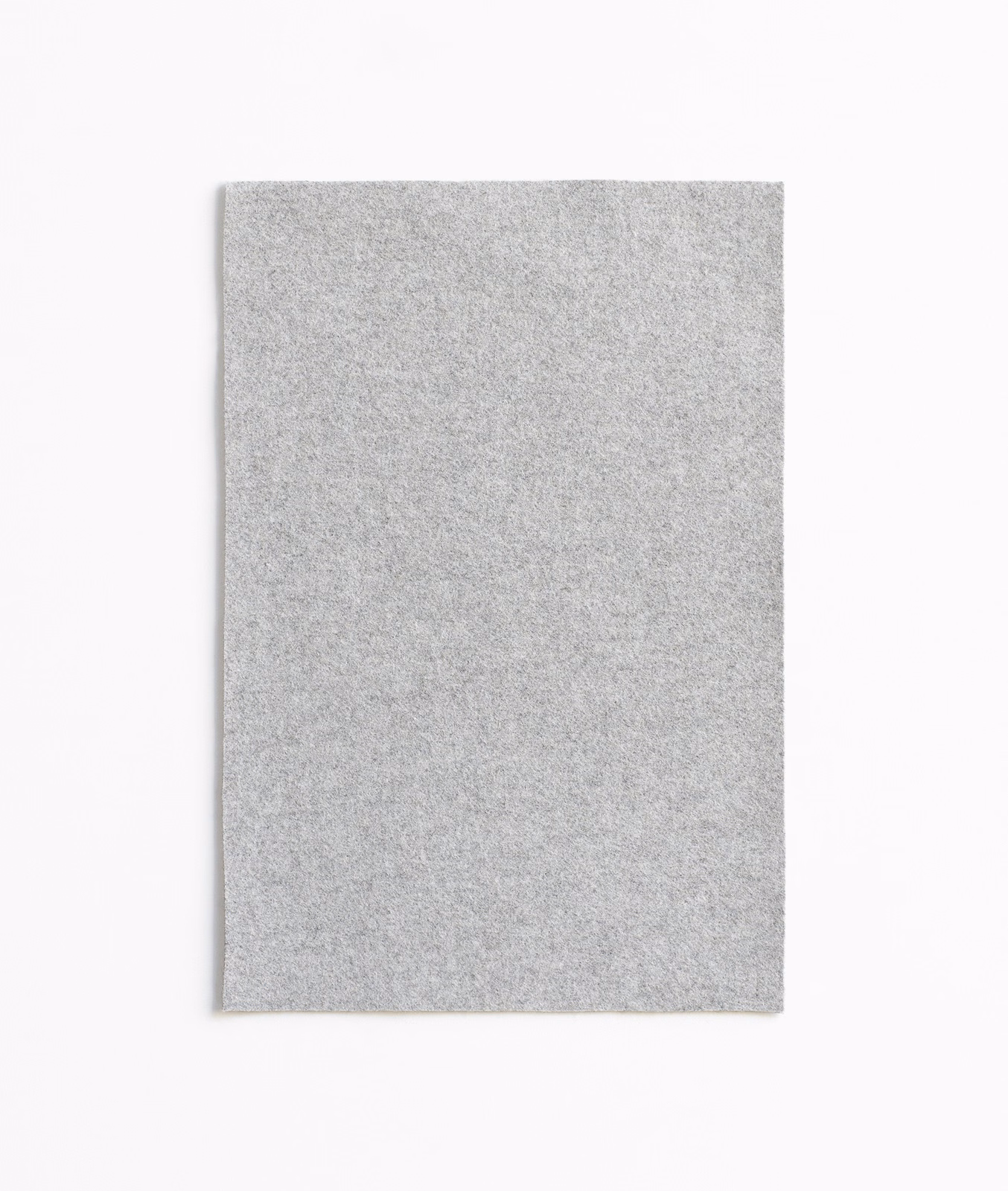 Cool pale grey swatch with a fine peppered weave and softly brushed texture