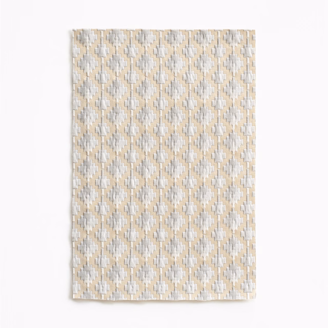 Pale pearl-beige woven swatch with repeating cream and grey diamond motifs