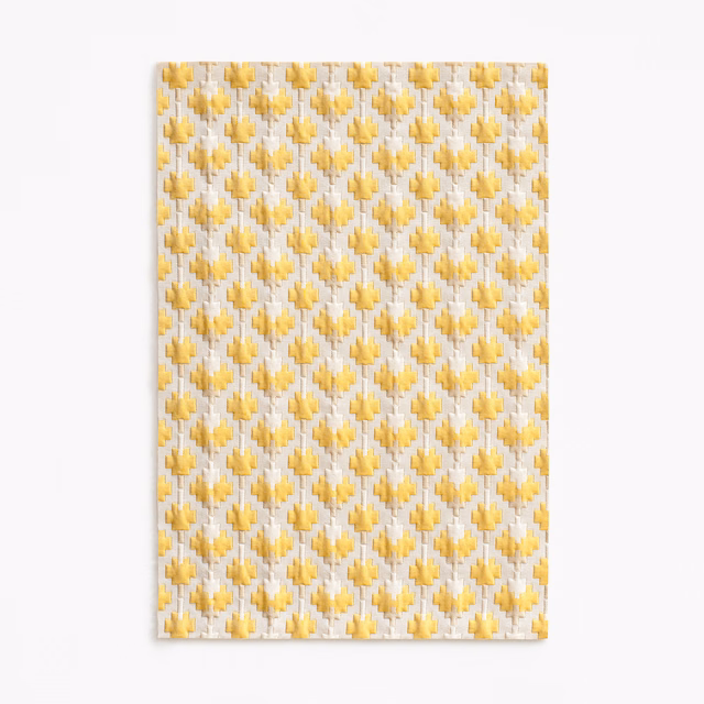 Ivory woven fabric with repeated small sunflower-gold geometric motifs